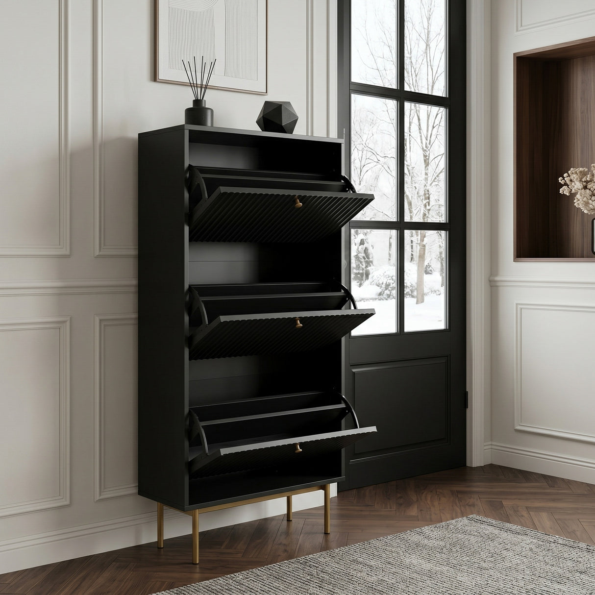 Black Devon Shoe Cabinet with three open tilt out compartments, gold handles and slim gold legs in modern hallway