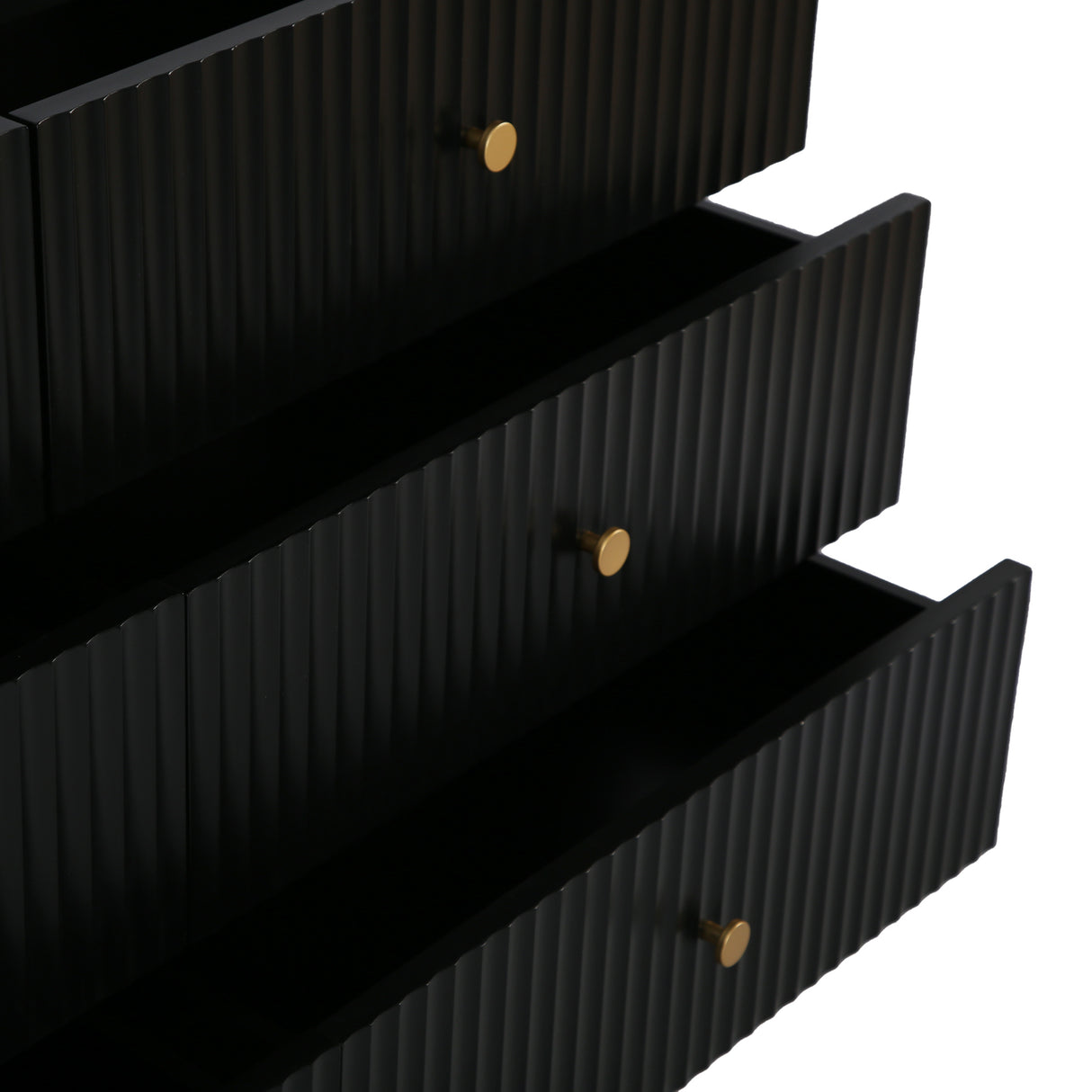 Close up of the black Devon Wide Chest of 6 Drawers showing partially open fluted drawers and gold handles.