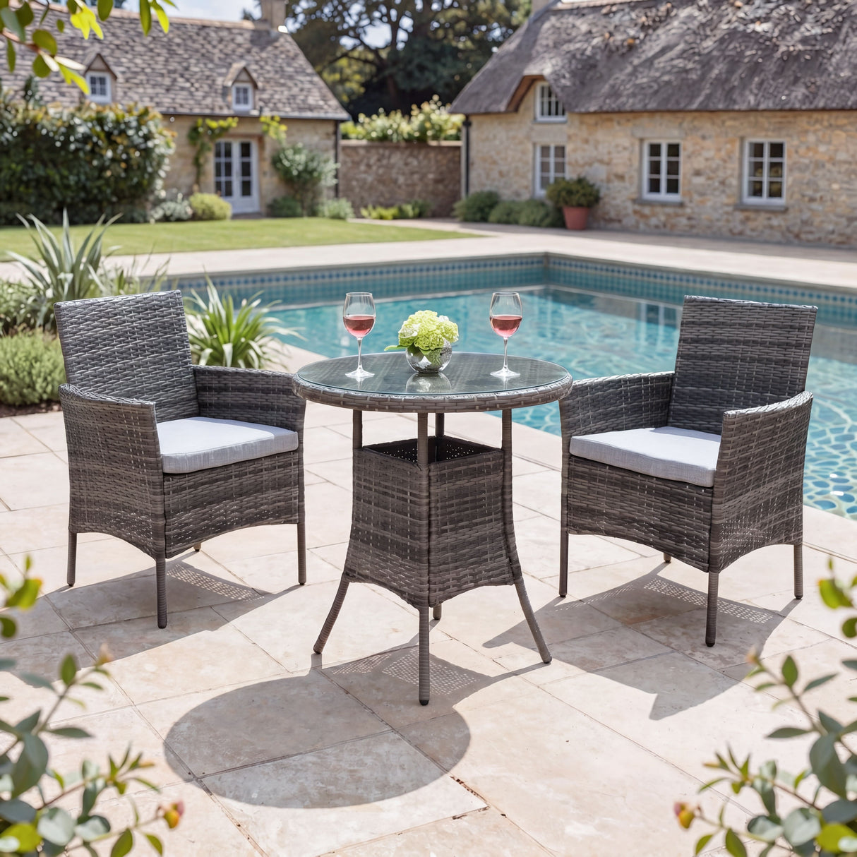 Outdoor patio set with table and chairs by a pool