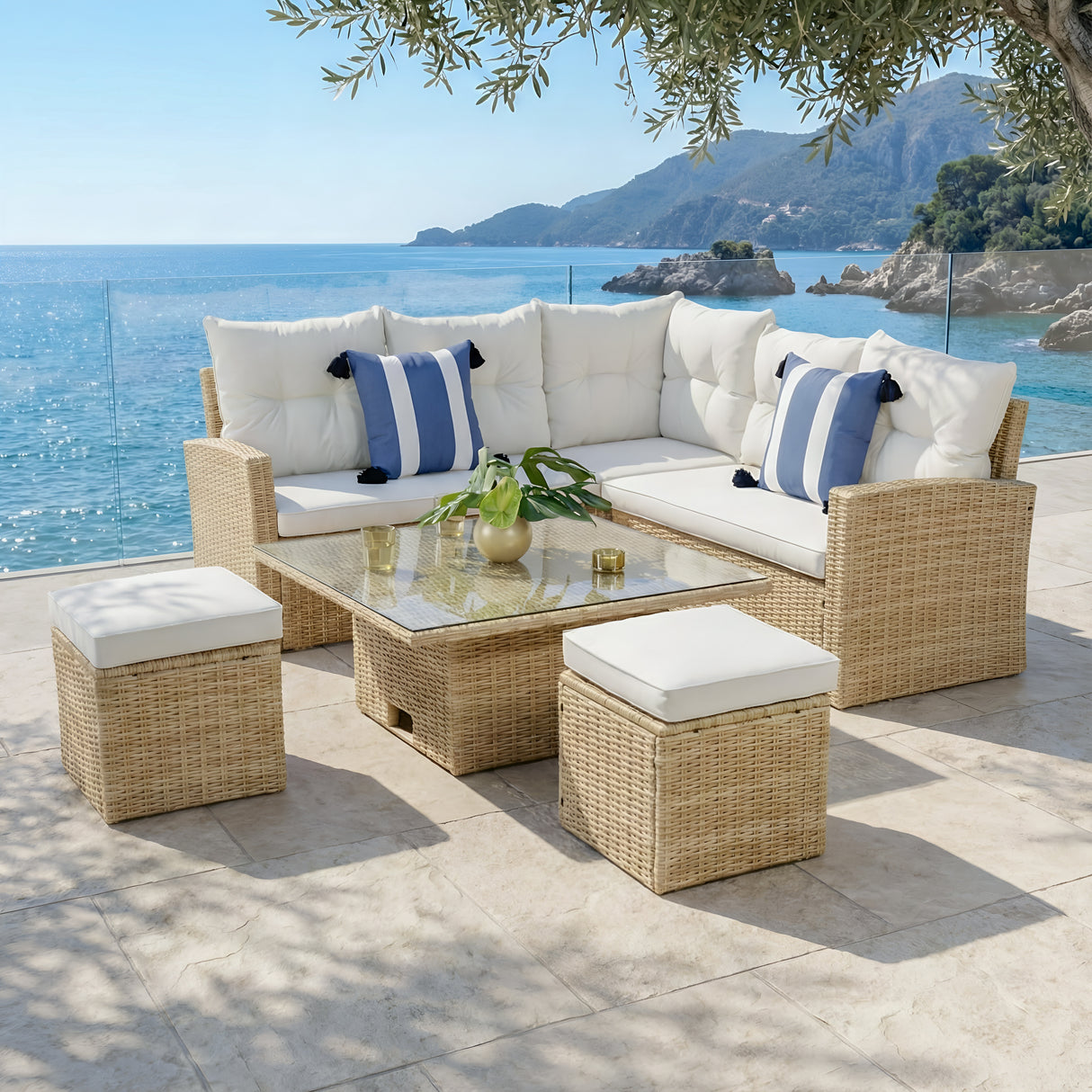 Outdoor patio furniture set with white cushions and blue striped pillows by a scenic waterfront.