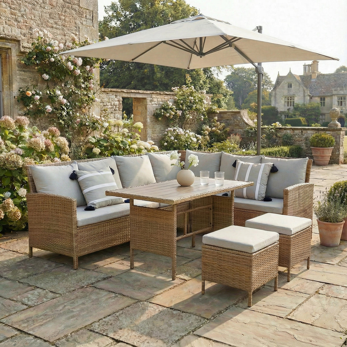 Outdoor patio set with cushions and umbrella on a stone patio. Brown with grey cushions