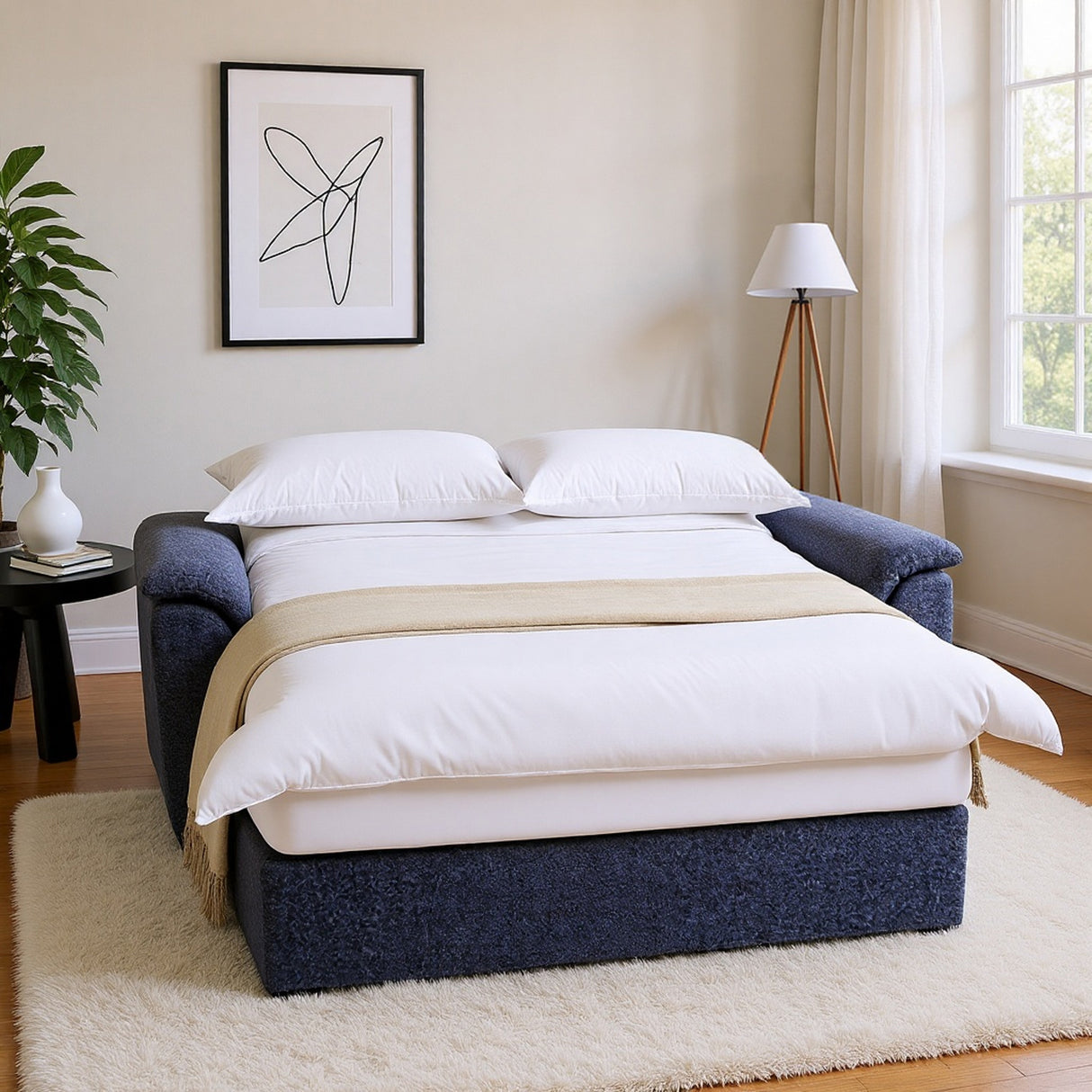 Navy blue bed frame with white bedding in a bright bedroom.