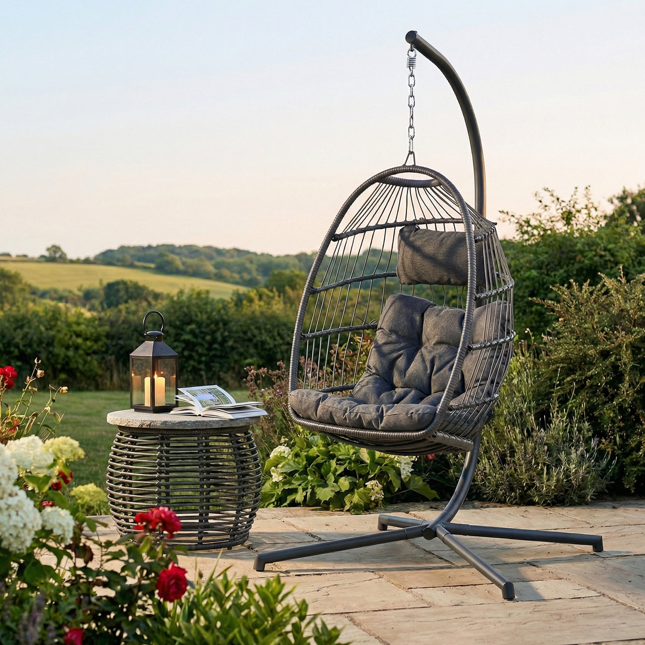 Hanging egg chair with cushions on a patio with a scenic background