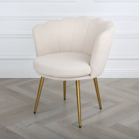 Flora cream boucle armchair with gold metal legs in a bright interior