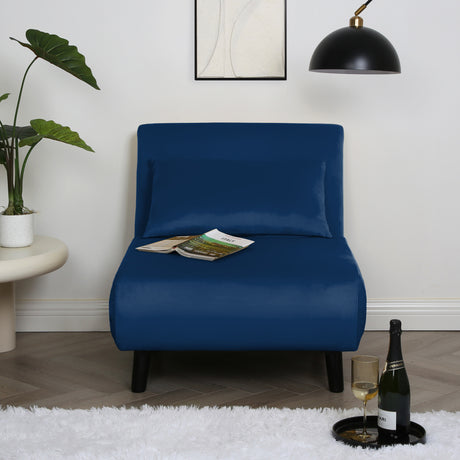 Navy blue Aurora Single Sofa Bed Chair in Velvet styled beside a floor lamp in a contemporary room.