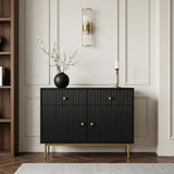 Black Devon cabinet with fluted doors, gold handles and slim gold legs, styled with a vase and candle in an elegant living space.