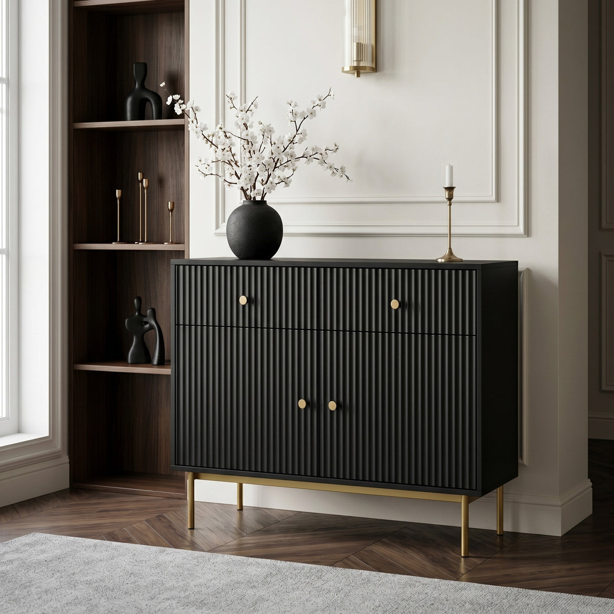 Black Devon cabinet with fluted doors, gold handles and slim gold legs, styled with a vase and candle in an elegant living space.