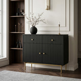 Black Devon cabinet with fluted doors, gold handles and slim gold legs, styled with a vase and candle in an elegant living space.