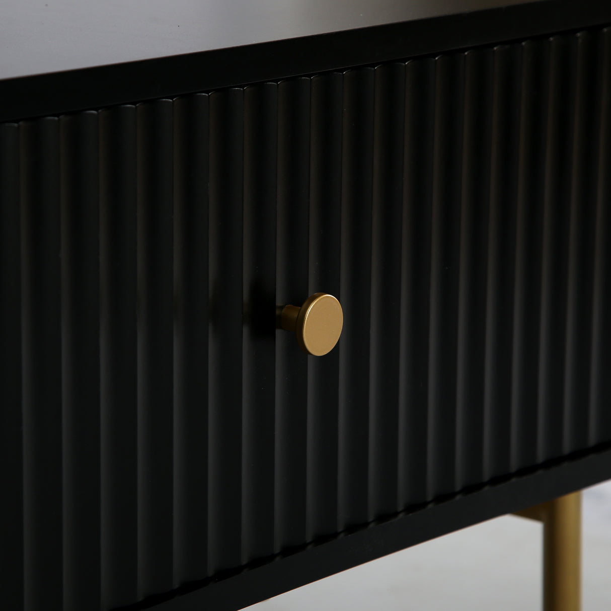 Close up of the Devon Rectangular Coffee Table fluted drawer front, gold handle and gold leg.