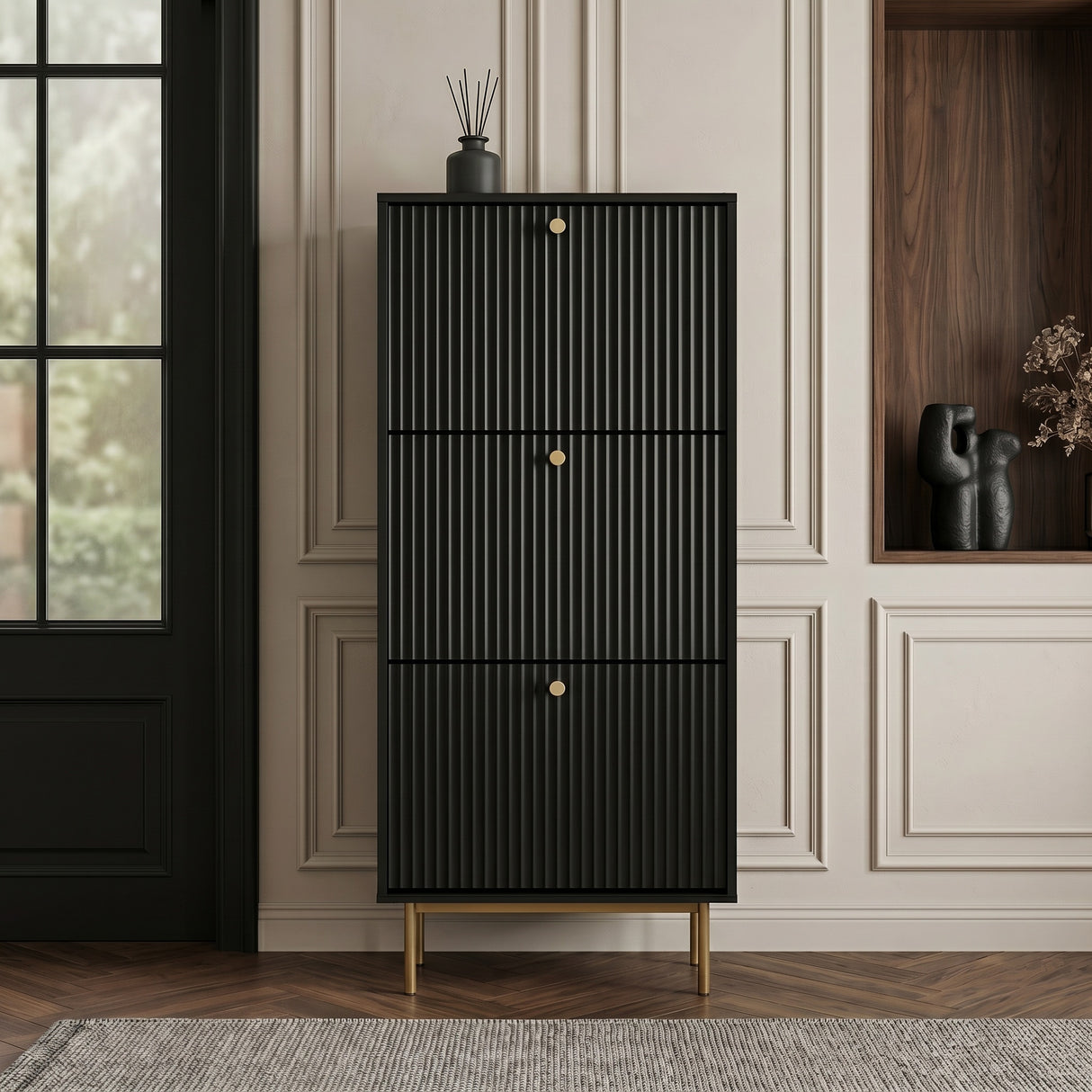 Black Shoe Cabinet with three fluted compartments, gold handles and slim gold legs, styled in a modern hallway.