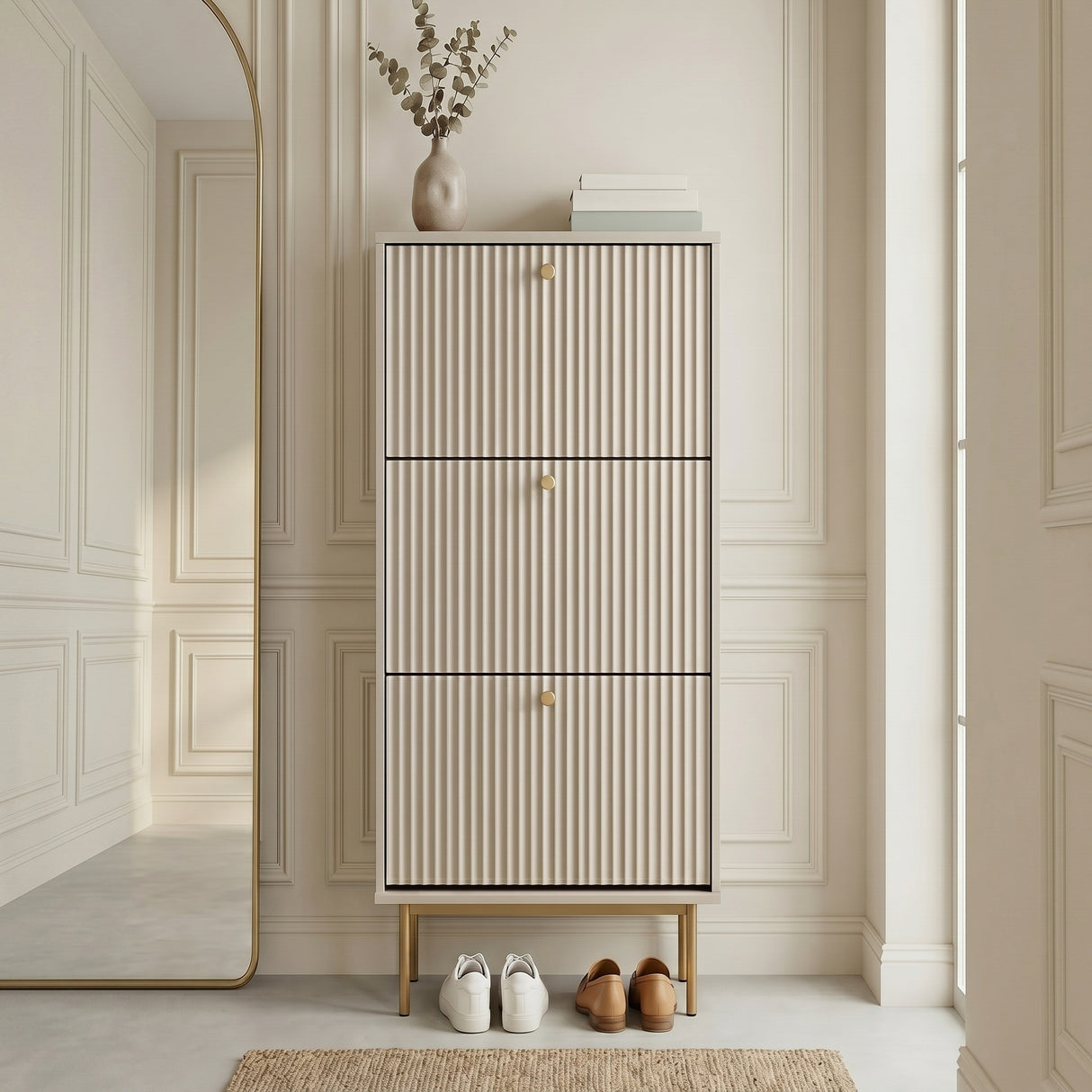 Grey Devon Shoe Cabinet with three fluted compartments, gold handles and slim gold legs, styled in a modern hallway.