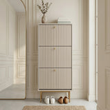 Grey Devon Shoe Cabinet with three fluted compartments, gold handles and slim gold legs, styled in a modern hallway.
