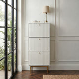 White Devon Shoe Cabinet with three fluted compartments, gold handles and slim gold legs, styled in a modern hallway.