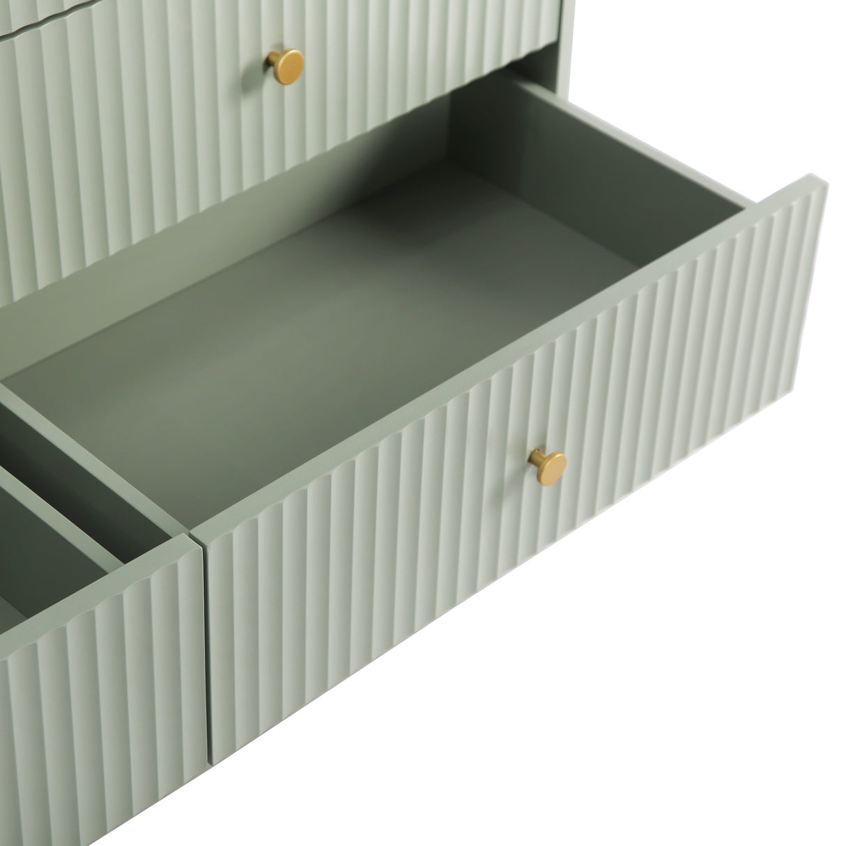 Close up of the sage green Devon Wide Chest of 6 Drawers showing an open drawer and fluted drawer front.