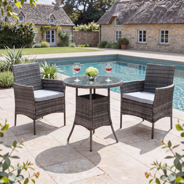 Outdoor patio set with table and chairs by a pool