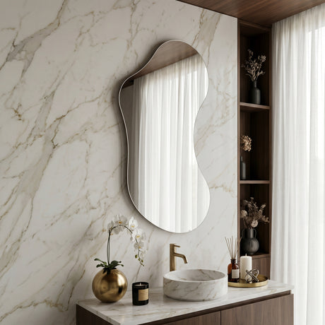 Lesina Frameless Pond Mirror styled above a bathroom vanity against a marble wall.