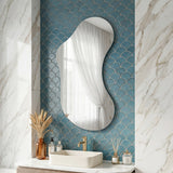 Lesina Frameless Pond Mirror styled above a sink in a contemporary bathroom with blue tiled walls.