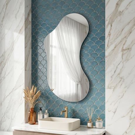 Lesina Frameless Pond Mirror styled above a sink in a contemporary bathroom with blue tiled walls.