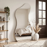 Lesina Frameless Full Length Pond Mirror styled in a bright bedroom with shelving and decorative accessories.
