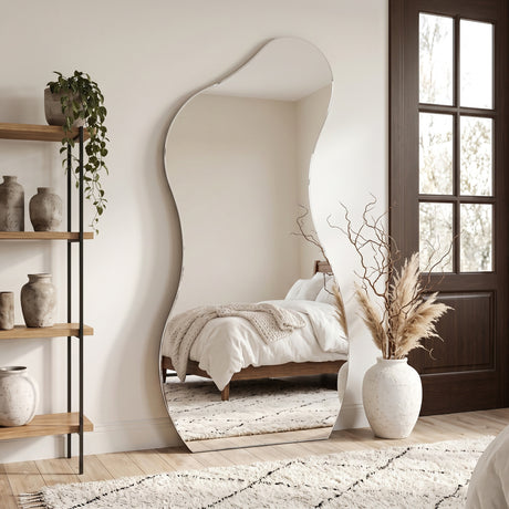 Lesina Frameless Full Length Pond Mirror styled in a bright bedroom with shelving and decorative accessories.