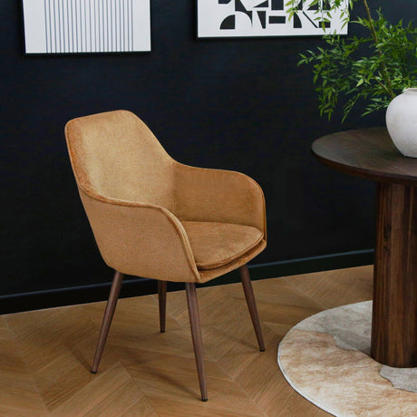 Orange Muse Accent Armchair displayed beside a round dining table