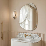 Nemi Frameless Irregular Pond Wall Mirror styled above a marble bathroom vanity