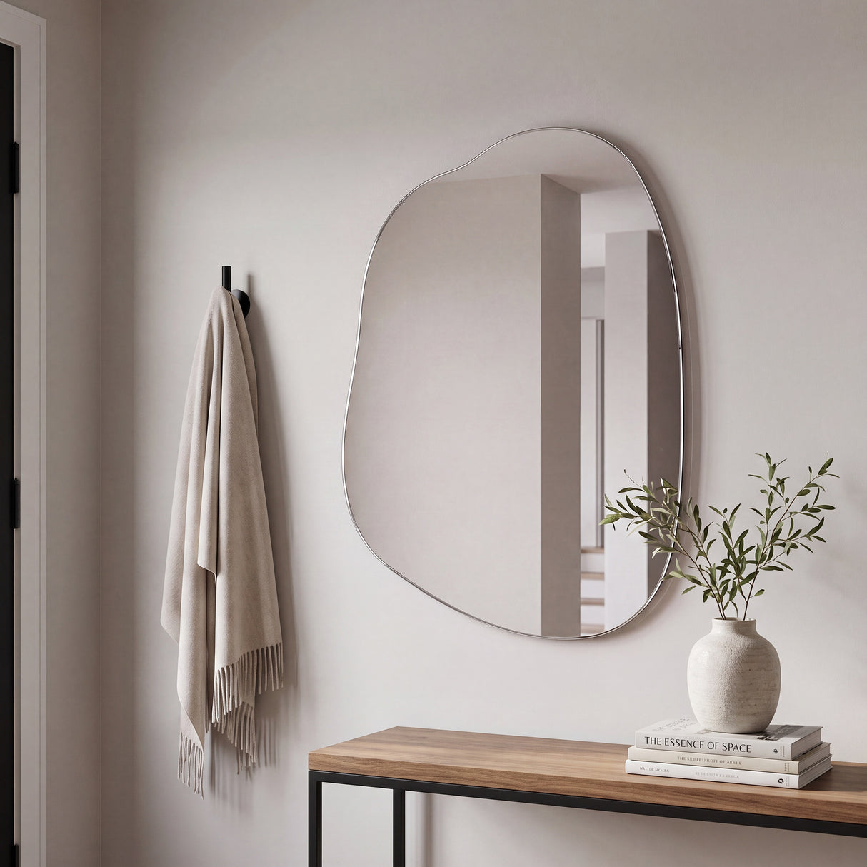 Nemi Frameless Irregular Pond Wall Mirror displayed above a console table