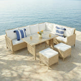 Outdoor patio furniture set with table and chairs on a stone patio by a body of water.