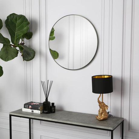 Pandora Round Wall Mirror with black frame styled above a console table